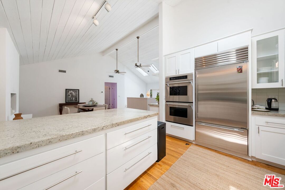 22760 Chamera Lane Topanga, CA 90290 - Photo 21 of 52 a kitchen with a sink and refrigerator