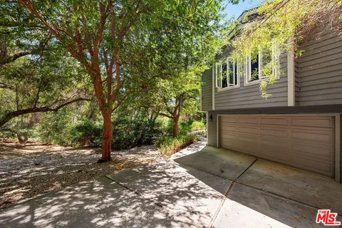 a view of a pathway of a house with fountain in middle of the house