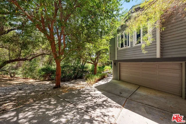 a view of a pathway of a house with fountain in middle of the house