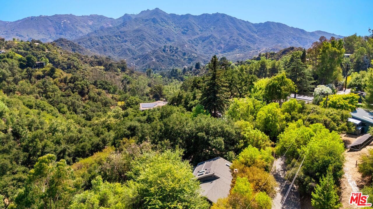 22760 Chamera Lane Topanga, CA 90290 - Photo 42 of 52 a view of a lush green hillside and a houses