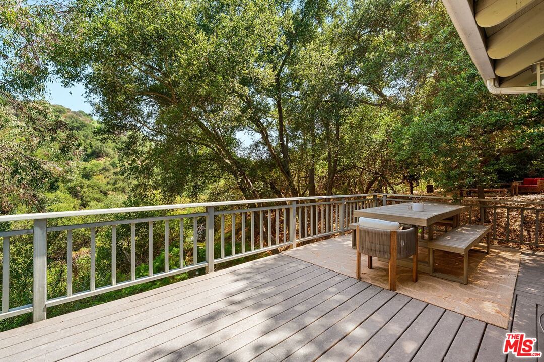 22760 Chamera Lane Topanga, CA 90290 - Photo 10 of 52 a view of a balcony with wooden floor and outdoor seating