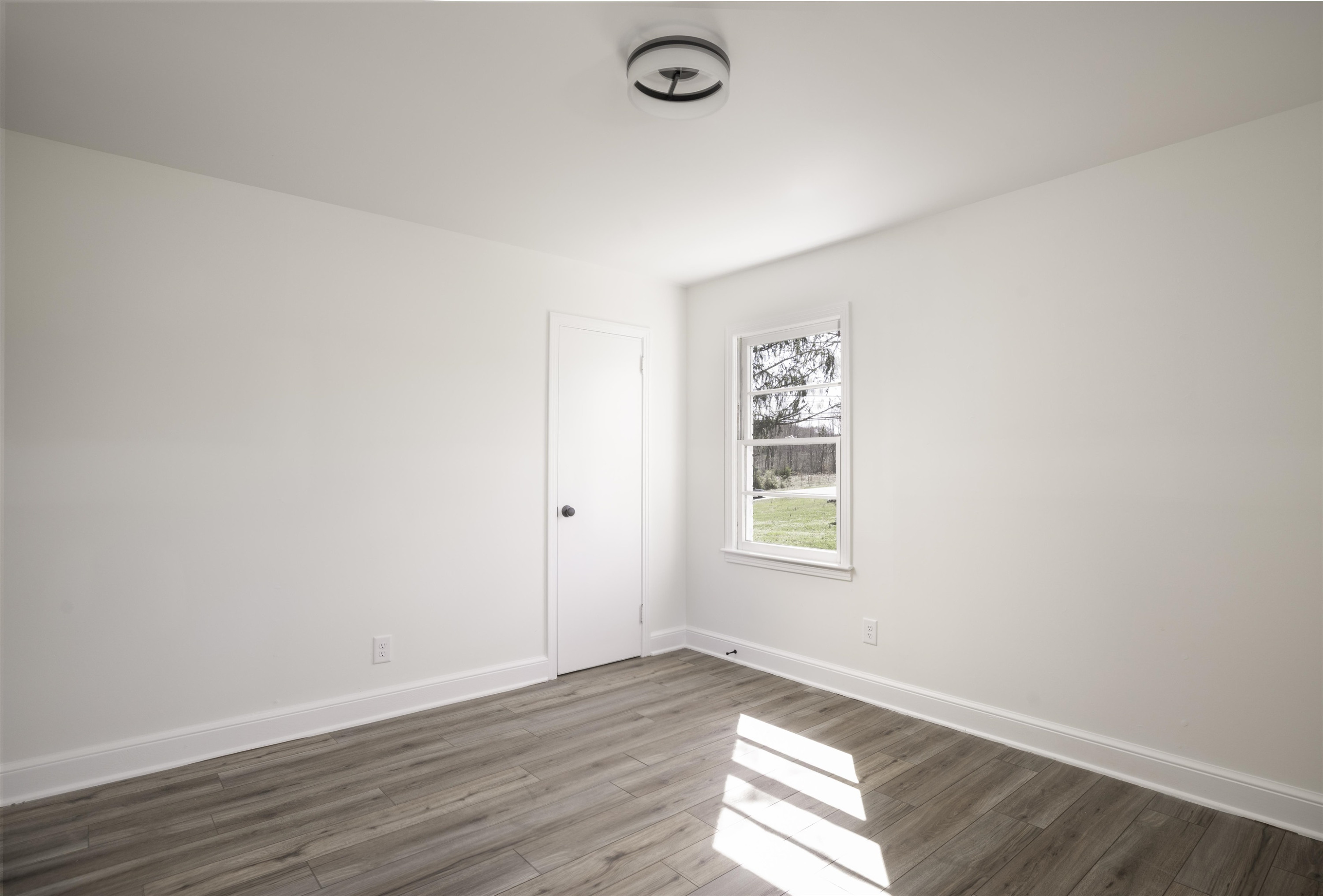 3555 Boston Road Roxboro, NC 27573 - Photo 8 of 21 an empty room with wooden floor and windows