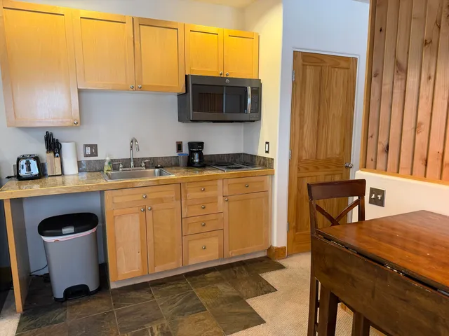 a kitchen with stainless steel appliances a stove a sink and a microwave