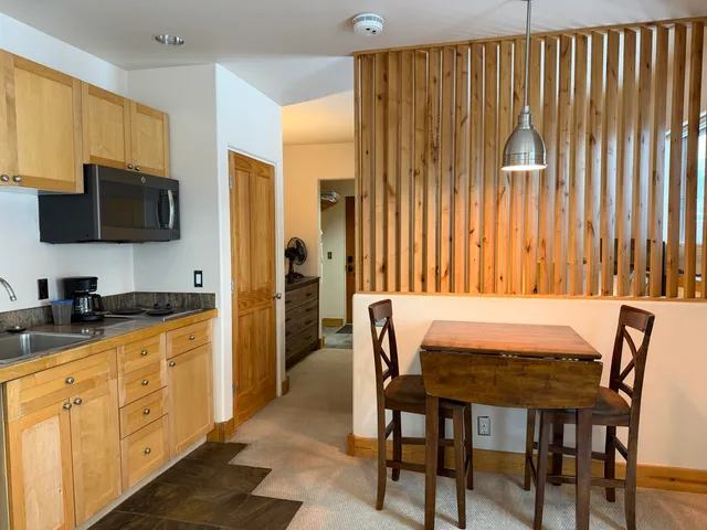 a dining room with furniture and a flat screen tv