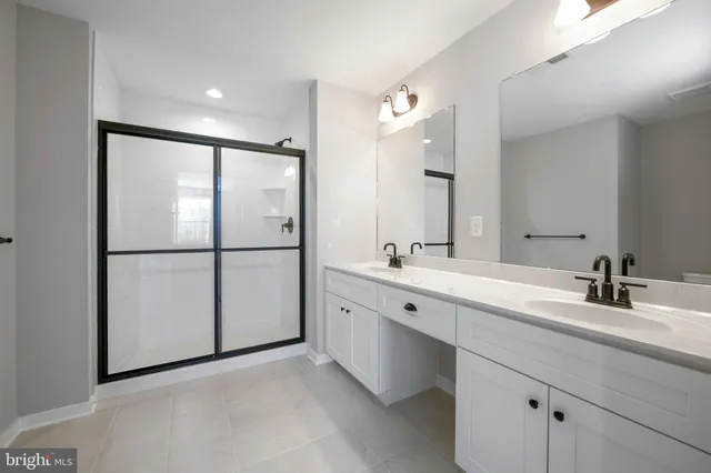 a bathroom with a double vanity sink and mirror