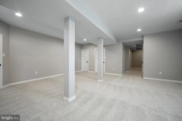 an empty room with an entrance to other room