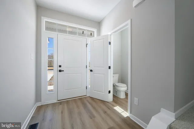 a bathroom view of a toilet and a shower