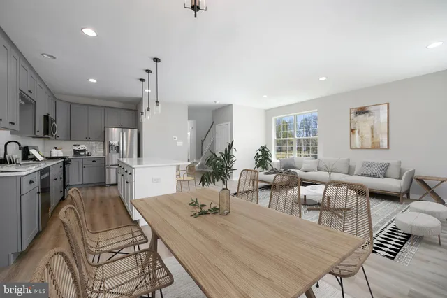 a living room with lots of furniture and kitchen view
