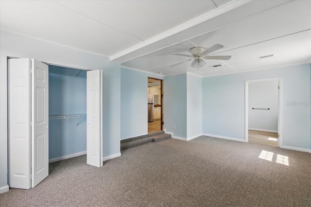 12301 Cedar Street Cedar Key, FL 32625 - Photo 16 of 38 a view of an empty room with a ceiling fan