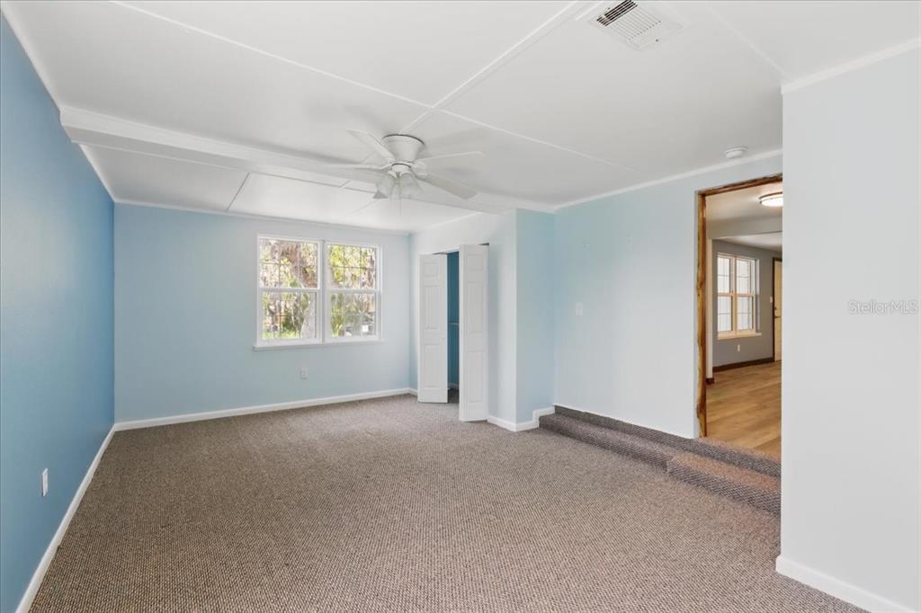 12301 Cedar Street Cedar Key, FL 32625 - Photo 18 of 38 an empty room with windows and closet