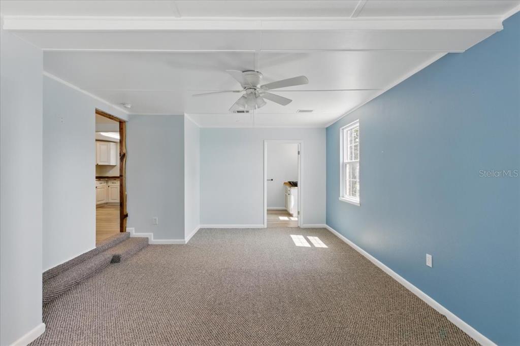 12301 Cedar Street Cedar Key, FL 32625 - Photo 19 of 38 wooden floor in an empty room with a window