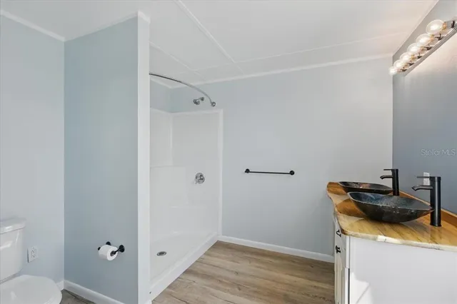 a white toilet sitting next to a bath tub shower
