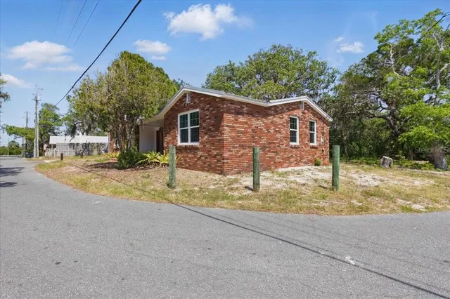 a view of a house with a tree in the background