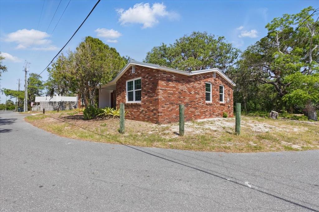 12301 Cedar Street Cedar Key, FL 32625 - Photo 2 of 38 a view of a house with a tree in the background