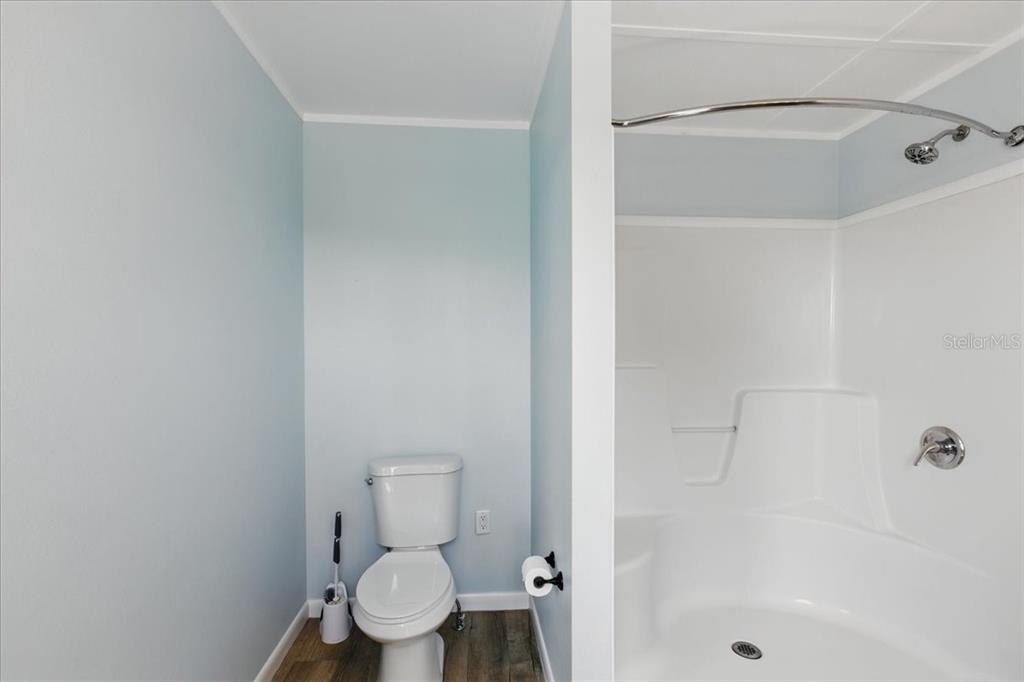 12301 Cedar Street Cedar Key, FL 32625 - Photo 21 of 38 a white toilet sitting next to a bath tub shower