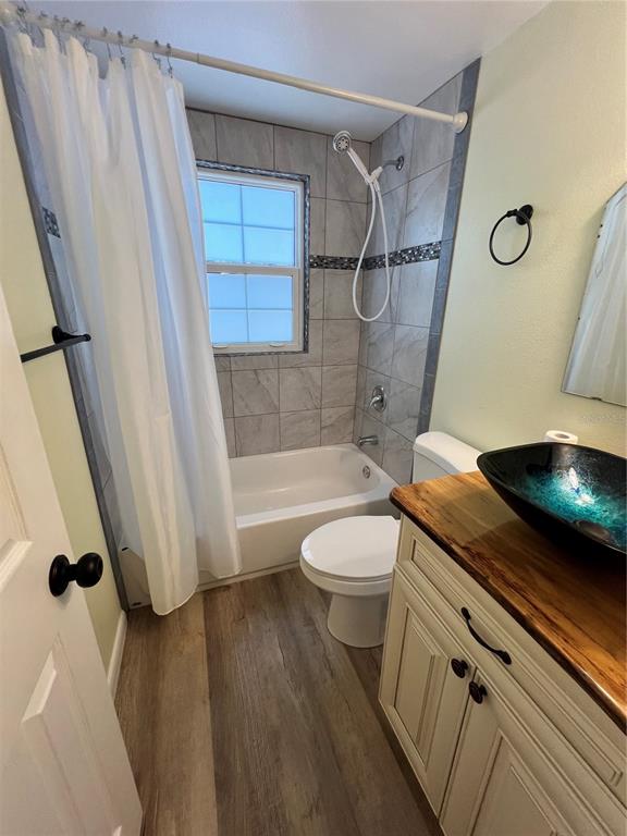 12301 Cedar Street Cedar Key, FL 32625 - Photo 25 of 38 a bathroom with a granite countertop sink toilet and shower