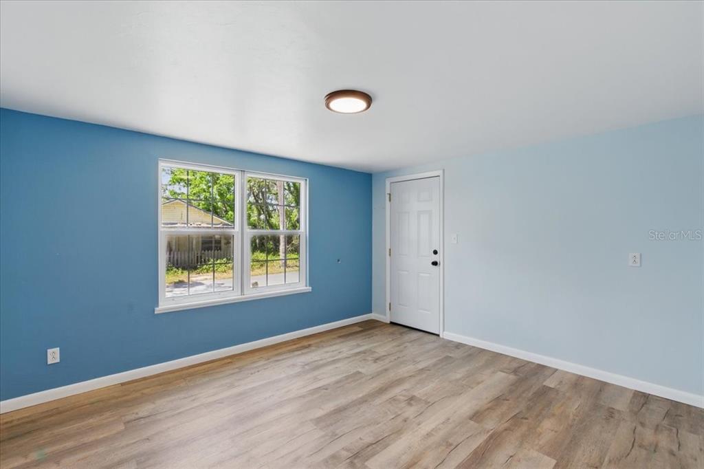 12301 Cedar Street Cedar Key, FL 32625 - Photo 27 of 38 a view of an empty room with wooden floor and a window