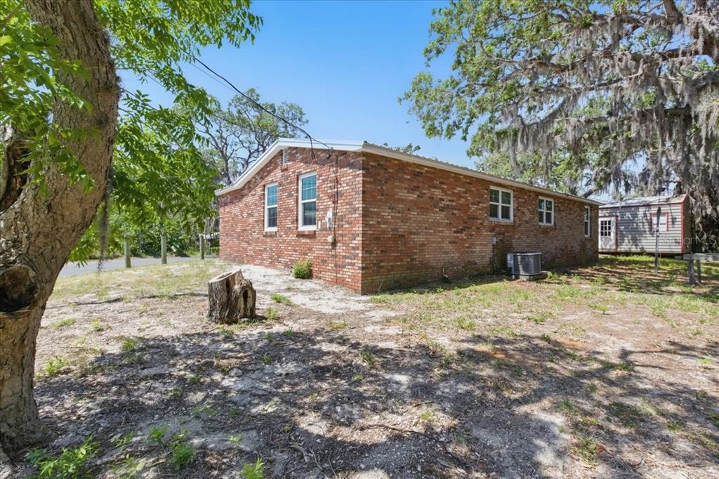 12301 Cedar Street Cedar Key, FL 32625 - Photo 28 of 38 a front view of a house with a yard