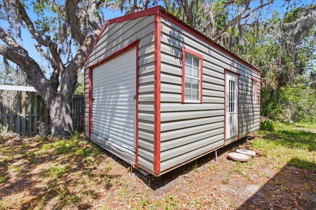 12301 Cedar Street Cedar Key, FL 32625 - Photo 32 of 38 a view of a small house with backyard and trees