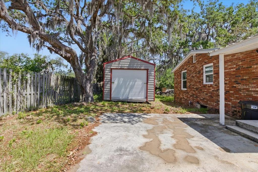 12301 Cedar Street Cedar Key, FL 32625 - Photo 34 of 38 a front view of a house with a yard and garage