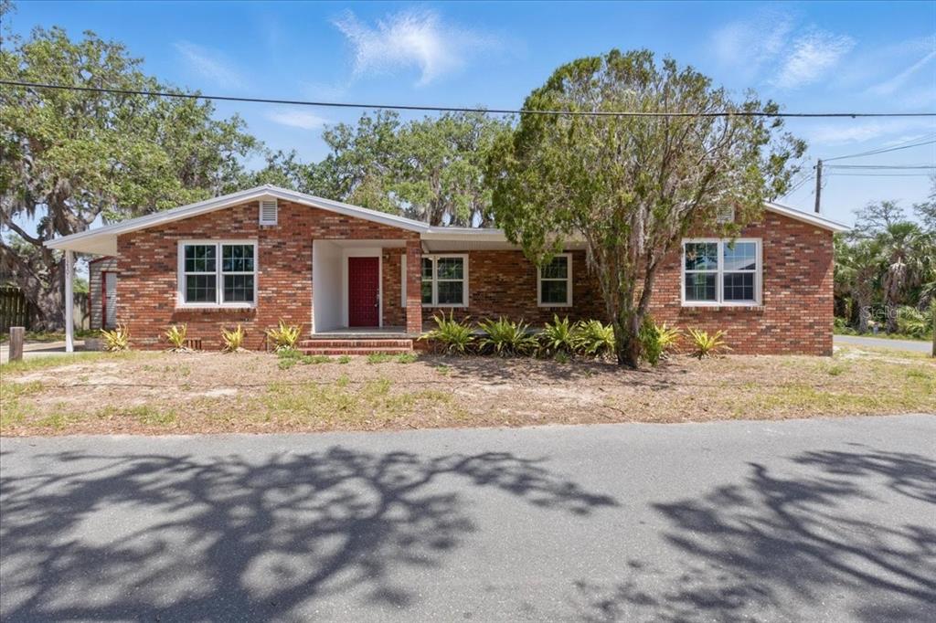 12301 Cedar Street Cedar Key, FL 32625 - Photo 4 of 38 a front view of house with yard and trees around