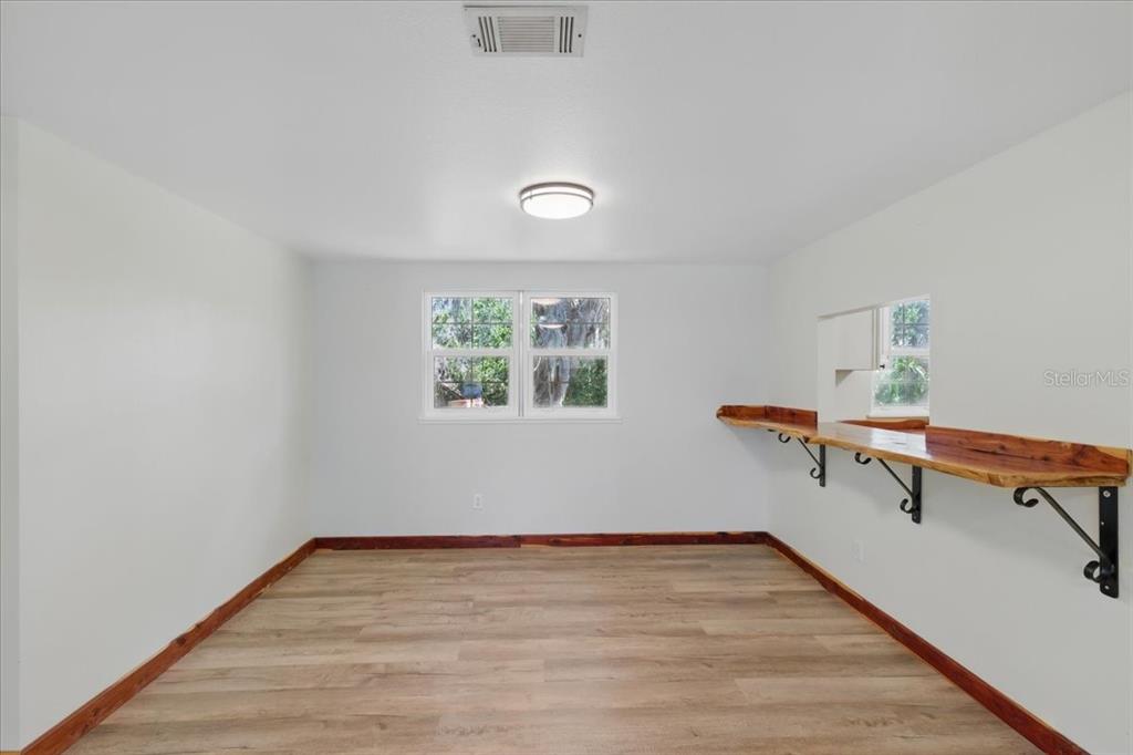 12301 Cedar Street Cedar Key, FL 32625 - Photo 6 of 38 a view of a room with wooden floor and small window
