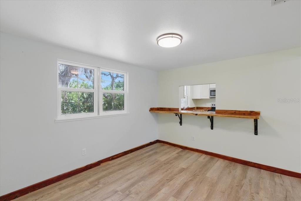 12301 Cedar Street Cedar Key, FL 32625 - Photo 7 of 38 a view of a room with a window and wooden floor