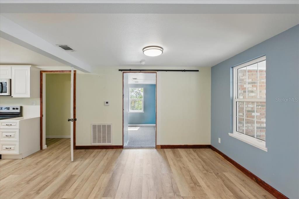 12301 Cedar Street Cedar Key, FL 32625 - Photo 10 of 38 wooden floor in an empty room with a window