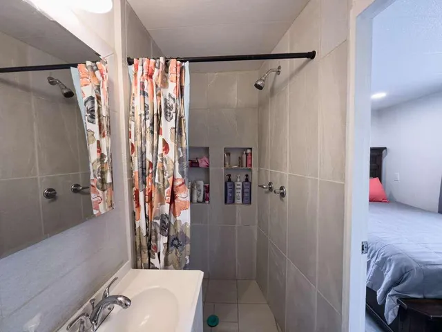 a bathroom with a shower curtain and a sink