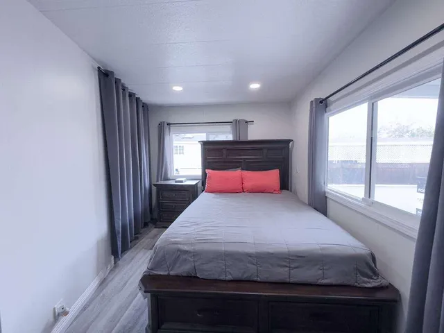 a bedroom with a bed and wooden floor