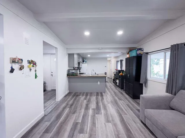 a view of a living room kitchen and a window