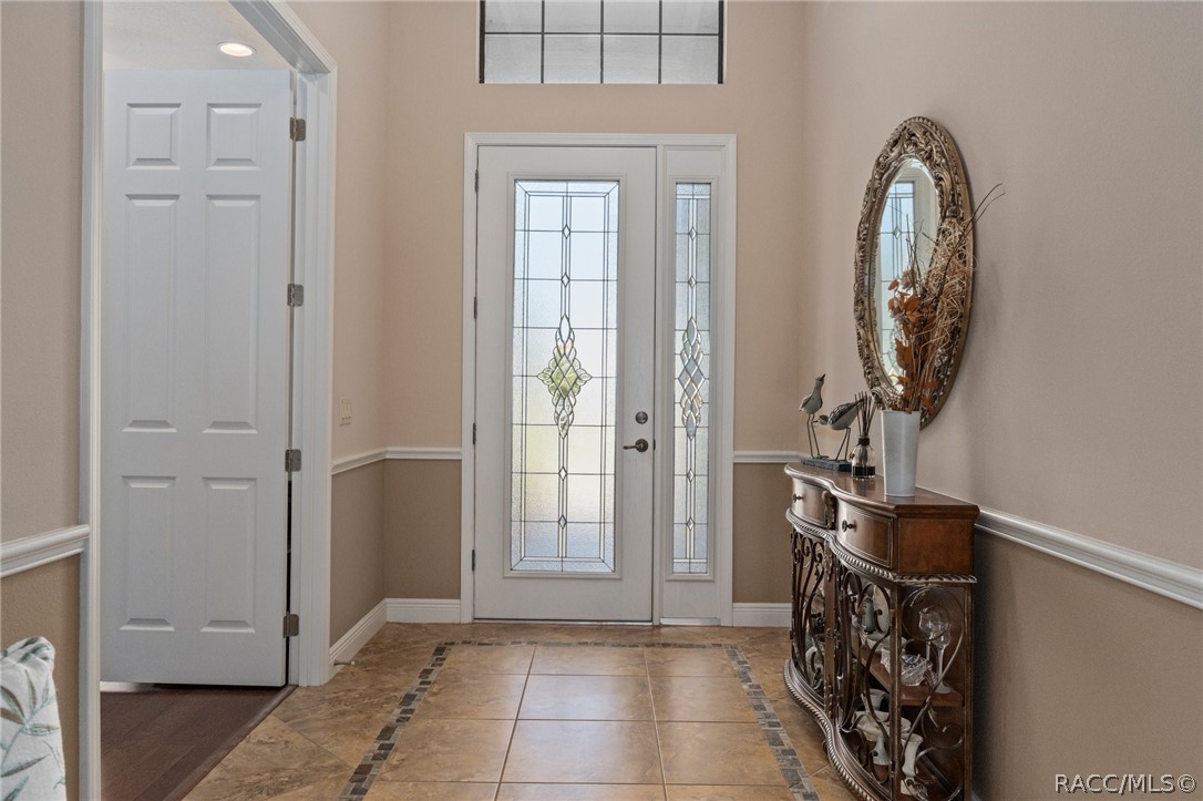 2015 North Rhodes Point Hernando, FL 34442 - Photo 5 of 82 The spacious entry is bathed in natural light through the leaded glass front door. The doorway to the left features 2 solid French doors and leads into the flex room, currently used as a den, but could easily become a 3rd bedroom.