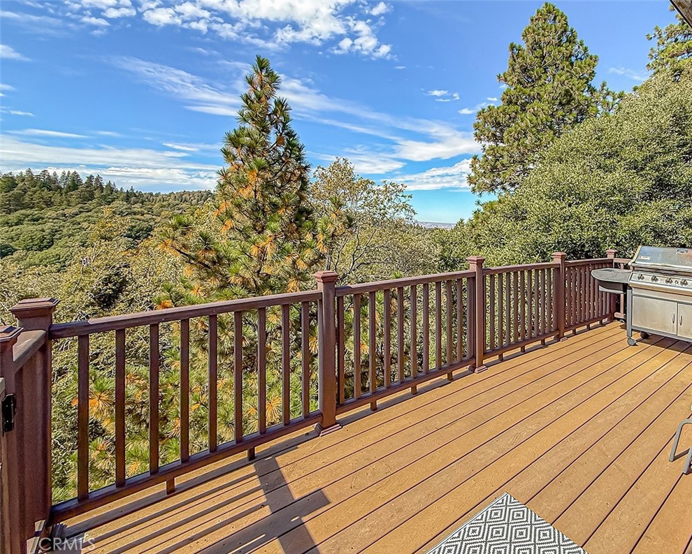 a view of a balcony with wooden floor and fence