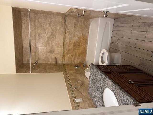 600 Frank E Rodgers Boulevard North, Unit 3 Harrison, NJ 07029 - Photo 15 of 16 a bathroom with a granite countertop sink a toilet and bathtub