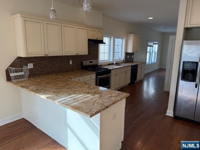 600 Frank E Rodgers Boulevard North, Unit 3 Harrison, NJ 07029 - Photo 3 of 16 a kitchen with granite countertop a sink a counter top space appliances and cabinets