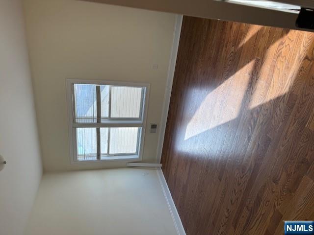 600 Frank E Rodgers Boulevard North, Unit 3 Harrison, NJ 07029 - Photo 8 of 16 a view of an empty room with wooden floor and window