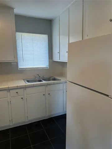 a kitchen with a sink and cabinets