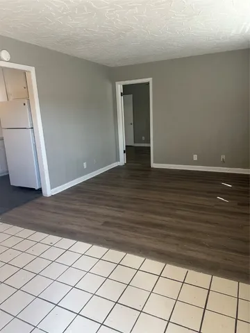 a view of an empty room and wooden floor