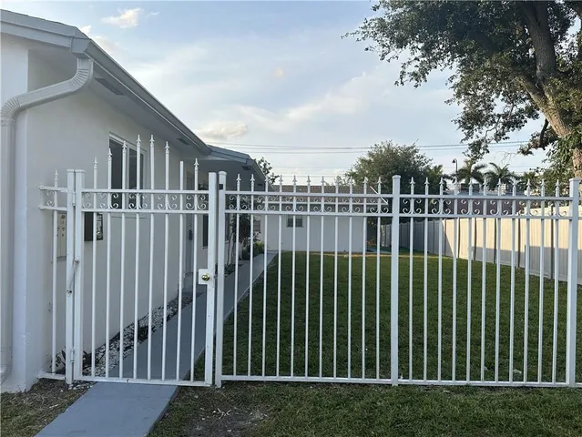 a view of a houses with a green space