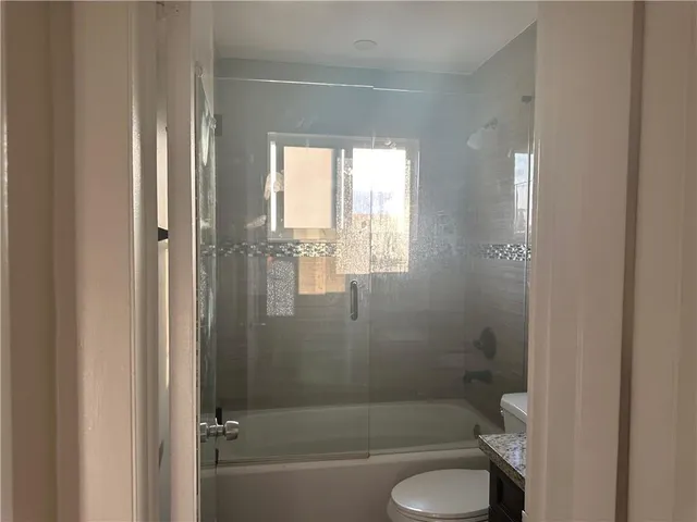 a bathroom with a shower and a toilet