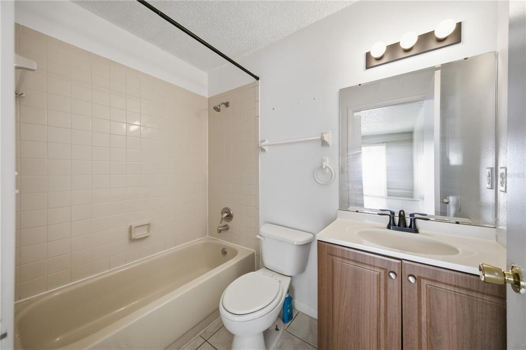 1836 Southwest 109th Place Ocala, FL 34476 - Photo 16 of 16 a bathroom with a bathtub shower sink vanity mirror and toilet