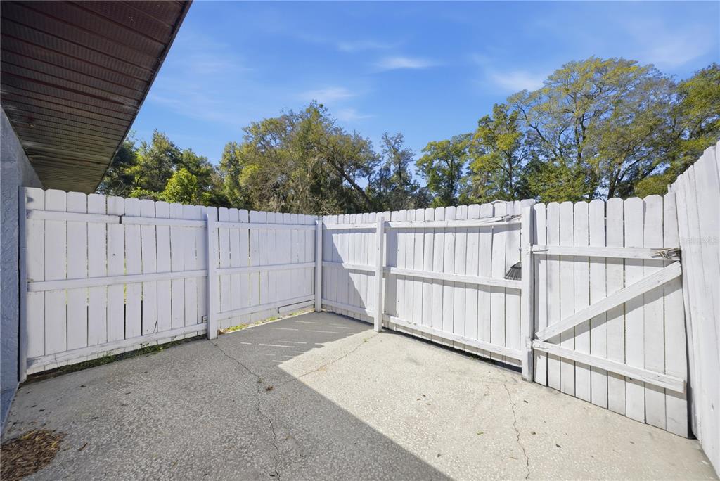 1836 Southwest 109th Place Ocala, FL 34476 - Photo 5 of 16 a view of backyard with wooden fence and trees