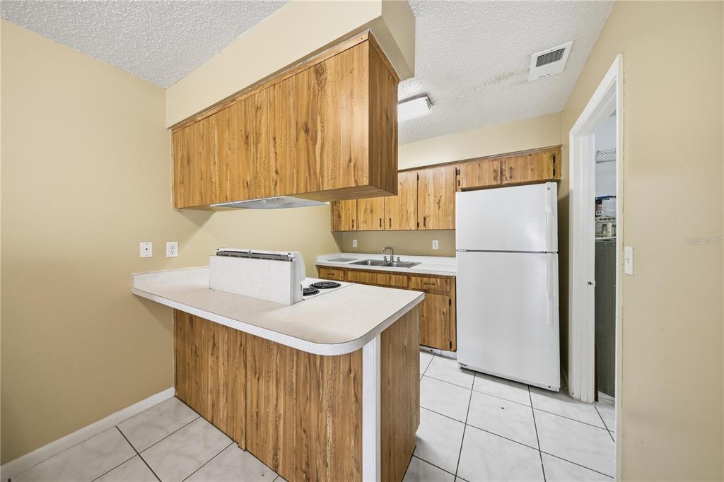 1836 Southwest 109th Place Ocala, FL 34476 - Photo 9 of 16 a kitchen with refrigerator a sink and dishwasher