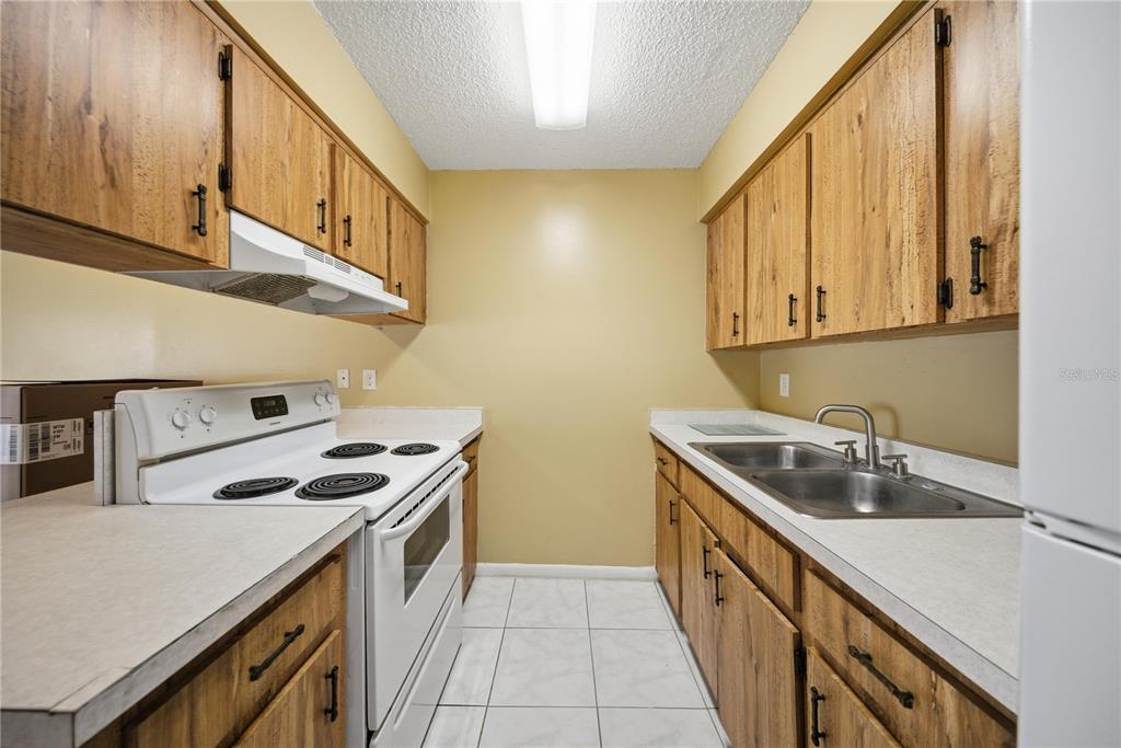 1836 Southwest 109th Place Ocala, FL 34476 - Photo 10 of 16 a kitchen that has a sink and a stove