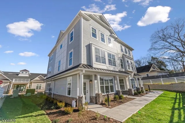 a front view of a residential apartment building with a yard