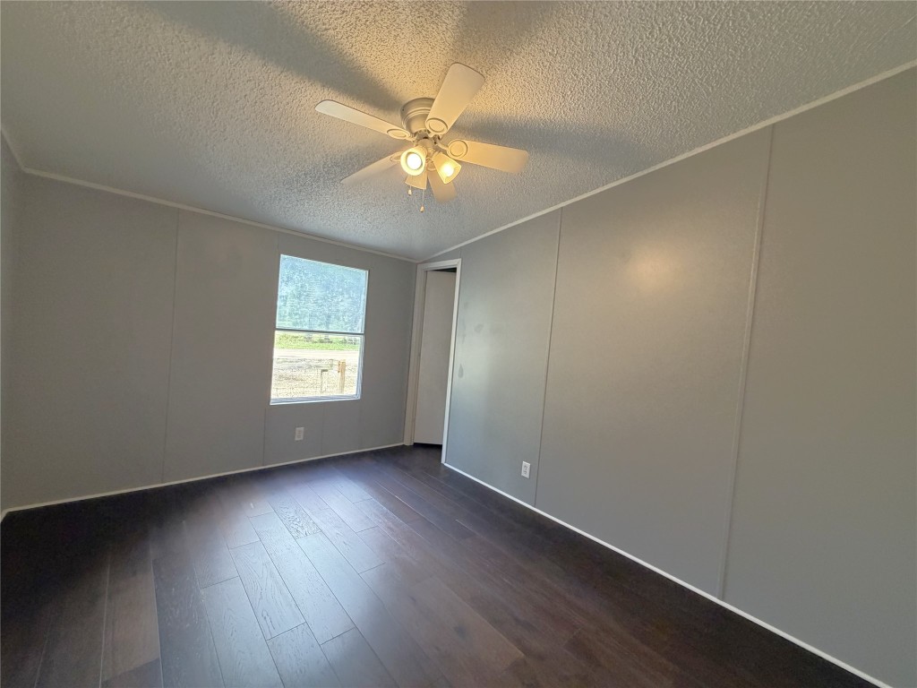 161 Farm To Market 1617 Trinity, TX 75862 - Photo 12 of 15 an empty room with wooden floor fan and windows