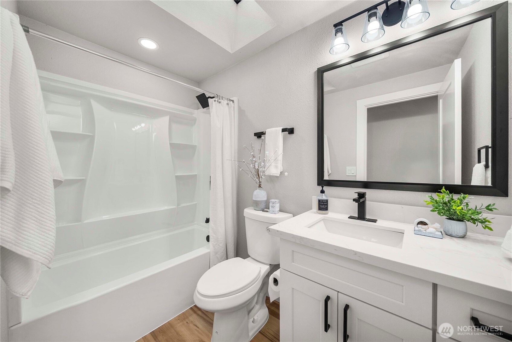 30150 10th Avenue Southwest Federal Way, WA 98023 - Photo 13 of 40 a bathroom with a sink a toilet and a large mirror