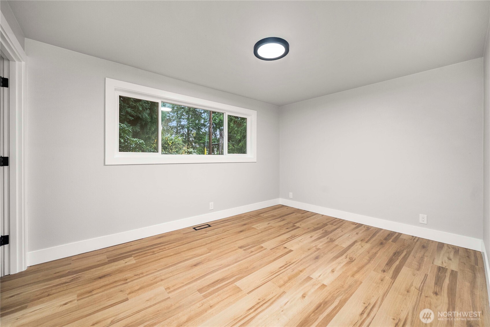 30150 10th Avenue Southwest Federal Way, WA 98023 - Photo 22 of 40 an empty room with wooden floor and windows