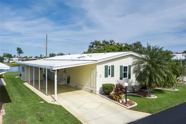 a view of a house with backyard and sitting area