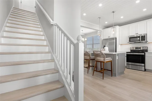 a view of kitchen with sink microwave and stove